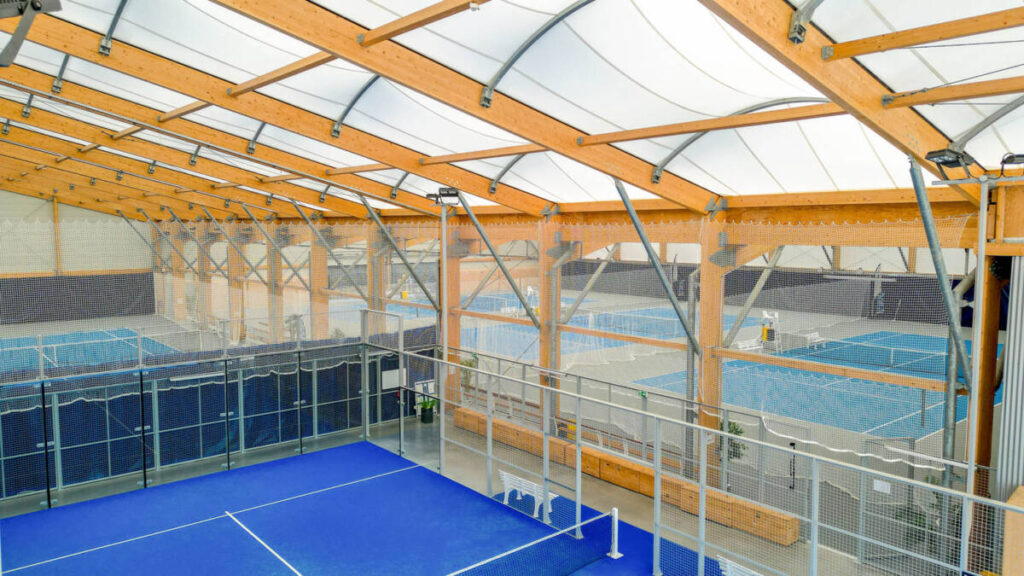 SMC2 a conçu et construit une halle sportive à Trélissac avec 4 courts de tennis et 2 de padel, alliant bois, acier et membrane textile.