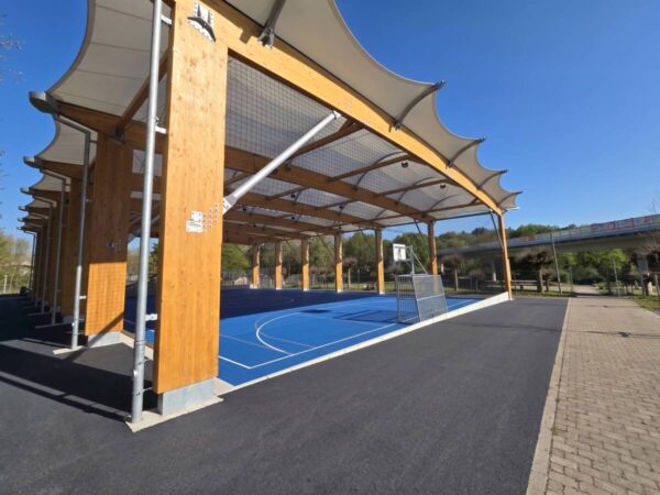 Seating steps formed by the foundations along the covered sports pitch