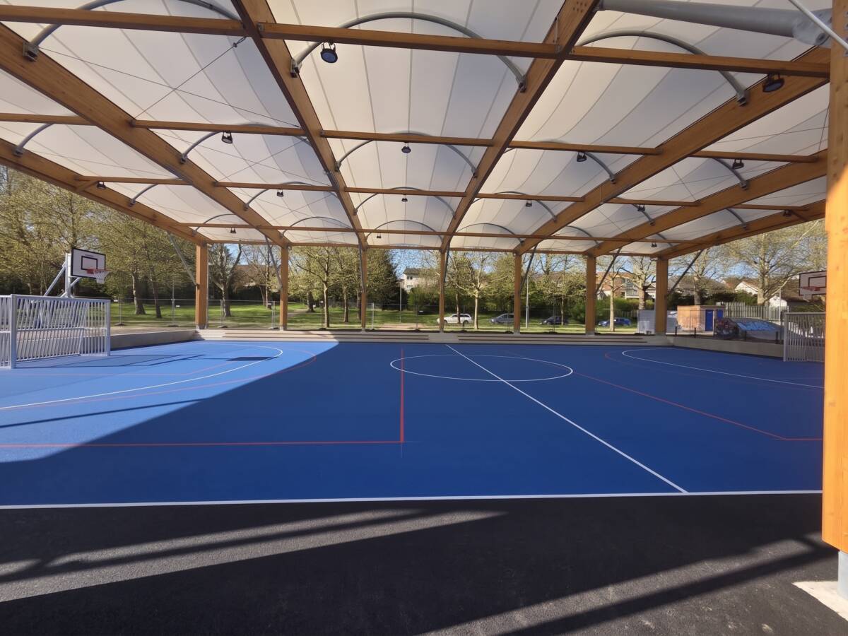 EPDM surface with basketball and handball markings under the tensile membrane roof